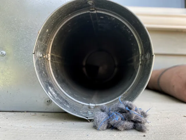 Trumbull Center Dryer Vent Cleaning technician using specialized equipment to clear severe dryer vent blockage in Trumbull Center